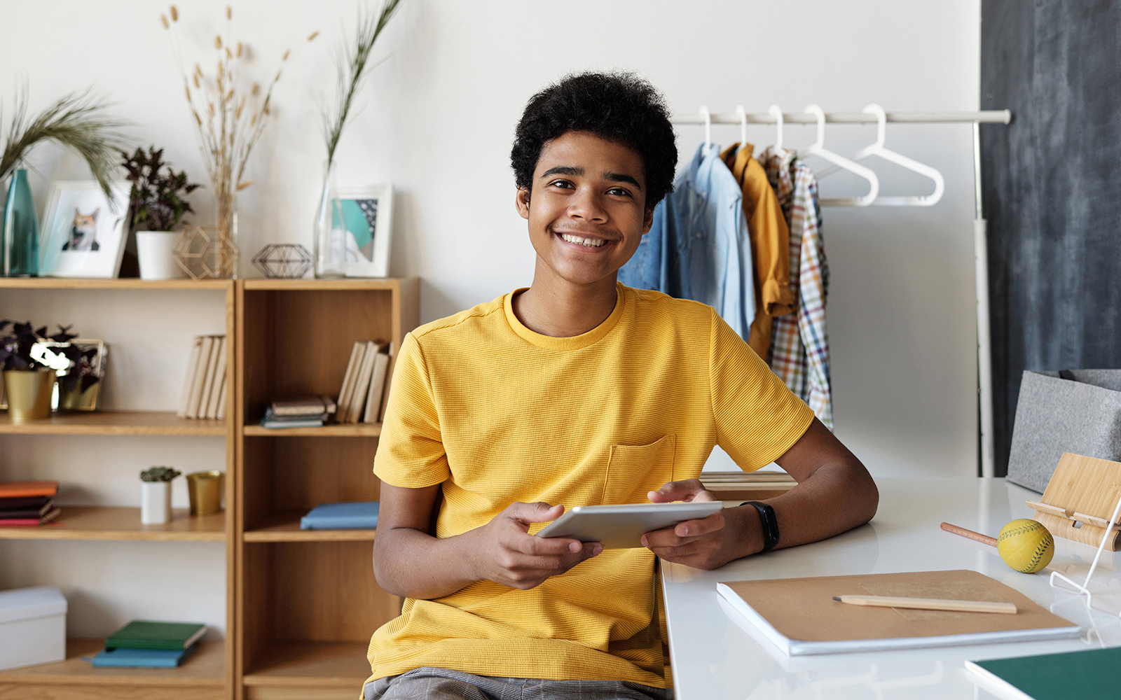 Teenage boy using tablet at desk