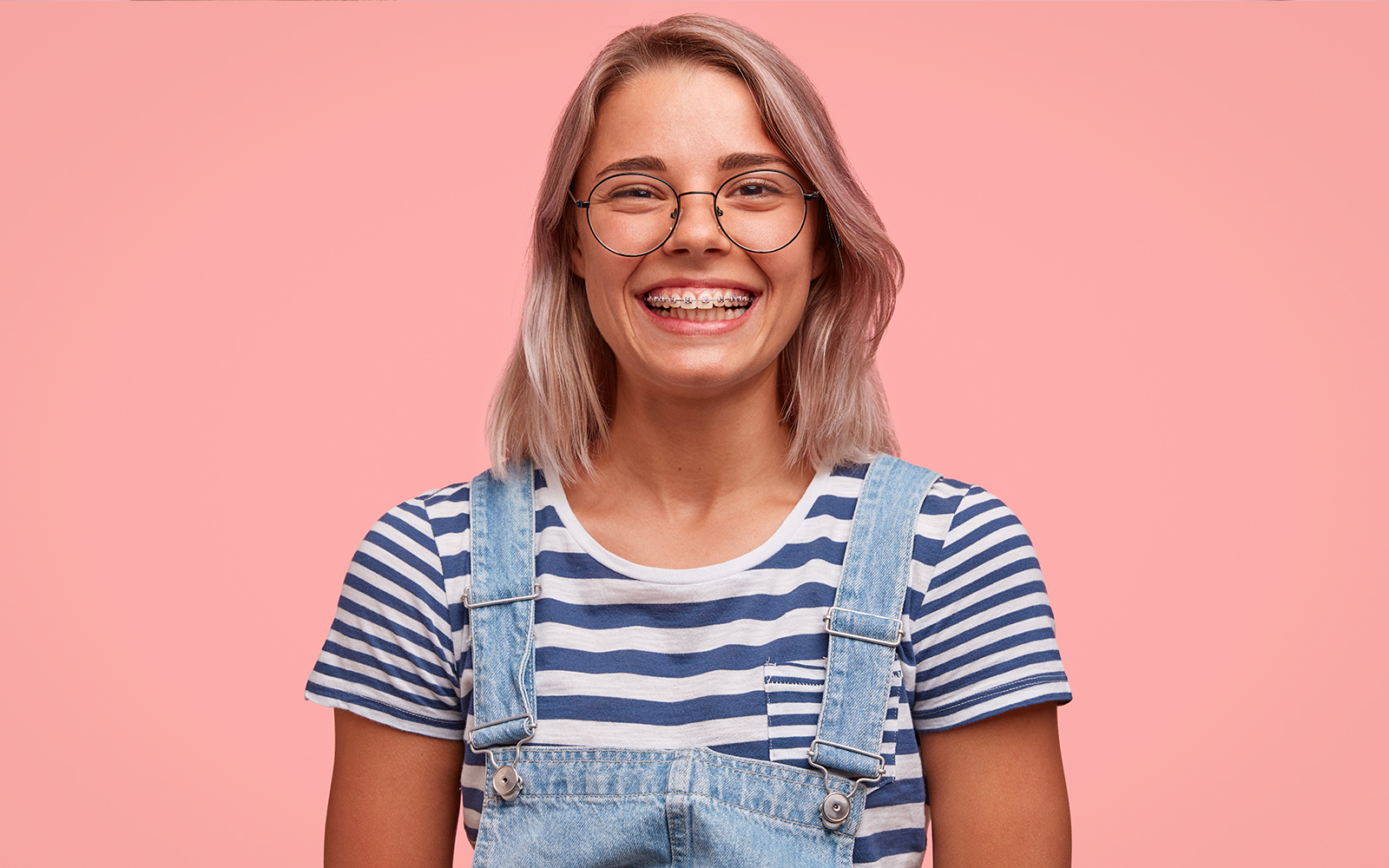 Young woman wearing braces and glasses in office building