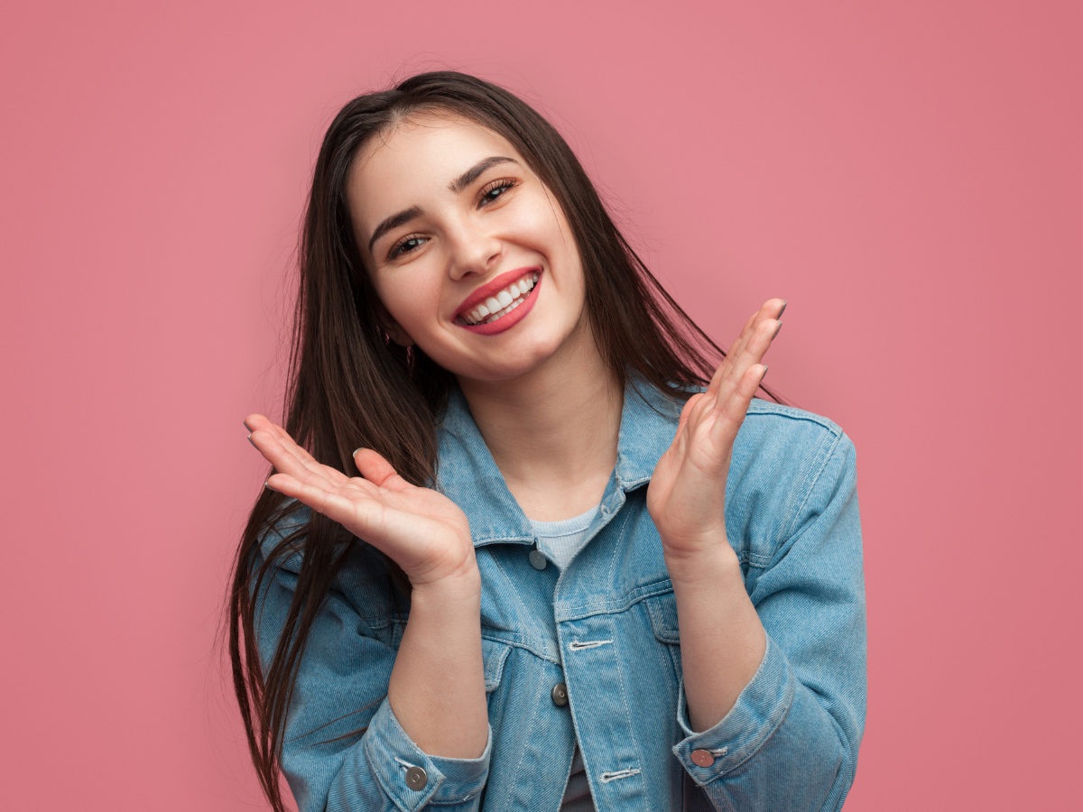 smiling girl with braces on pink background