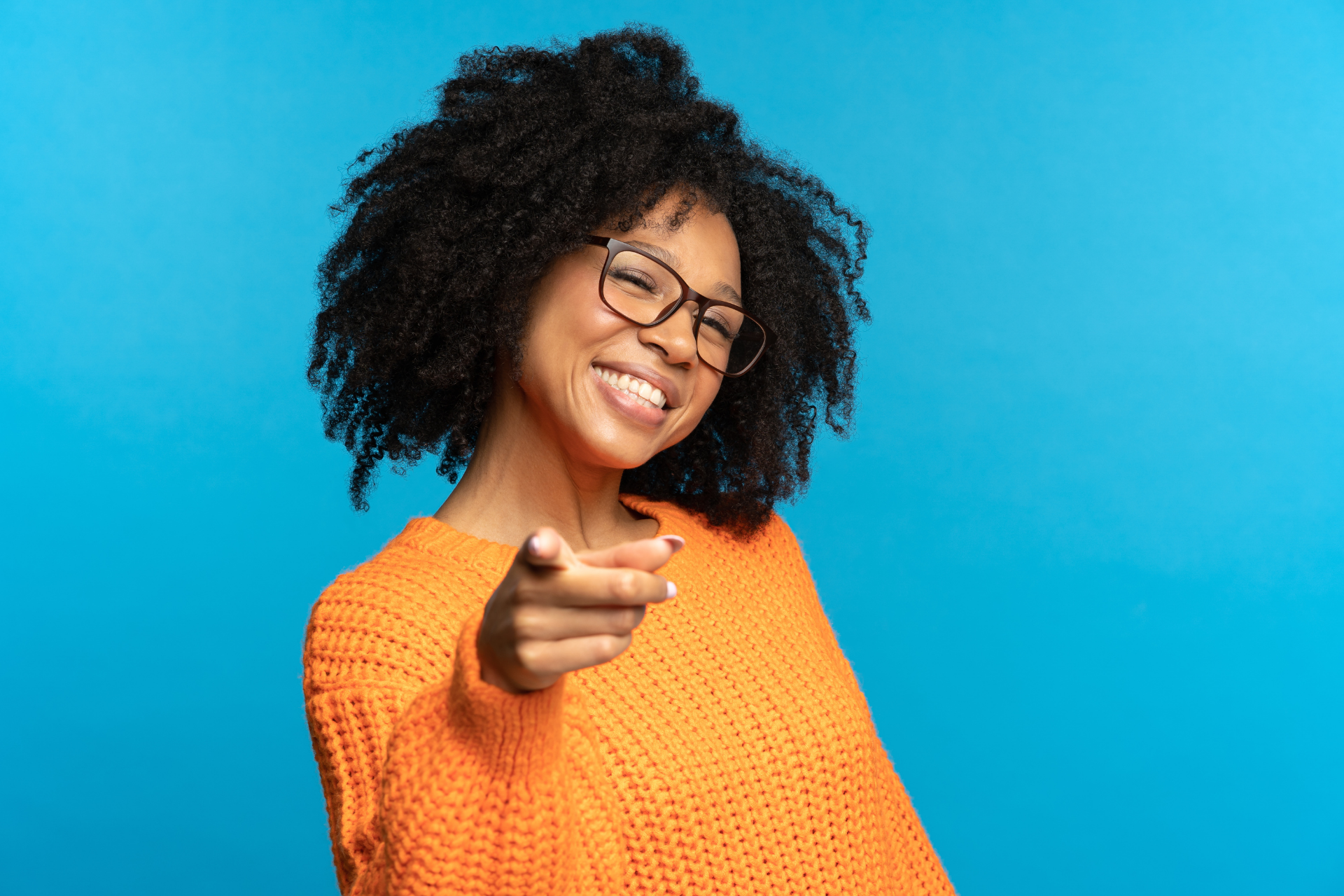 black woman with bright smile on blue background