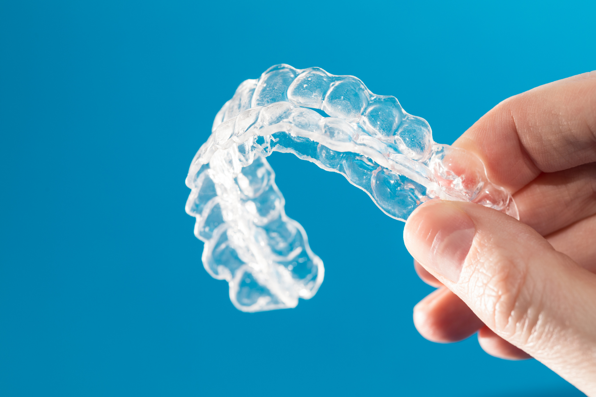 invisalgin aligners on blue background