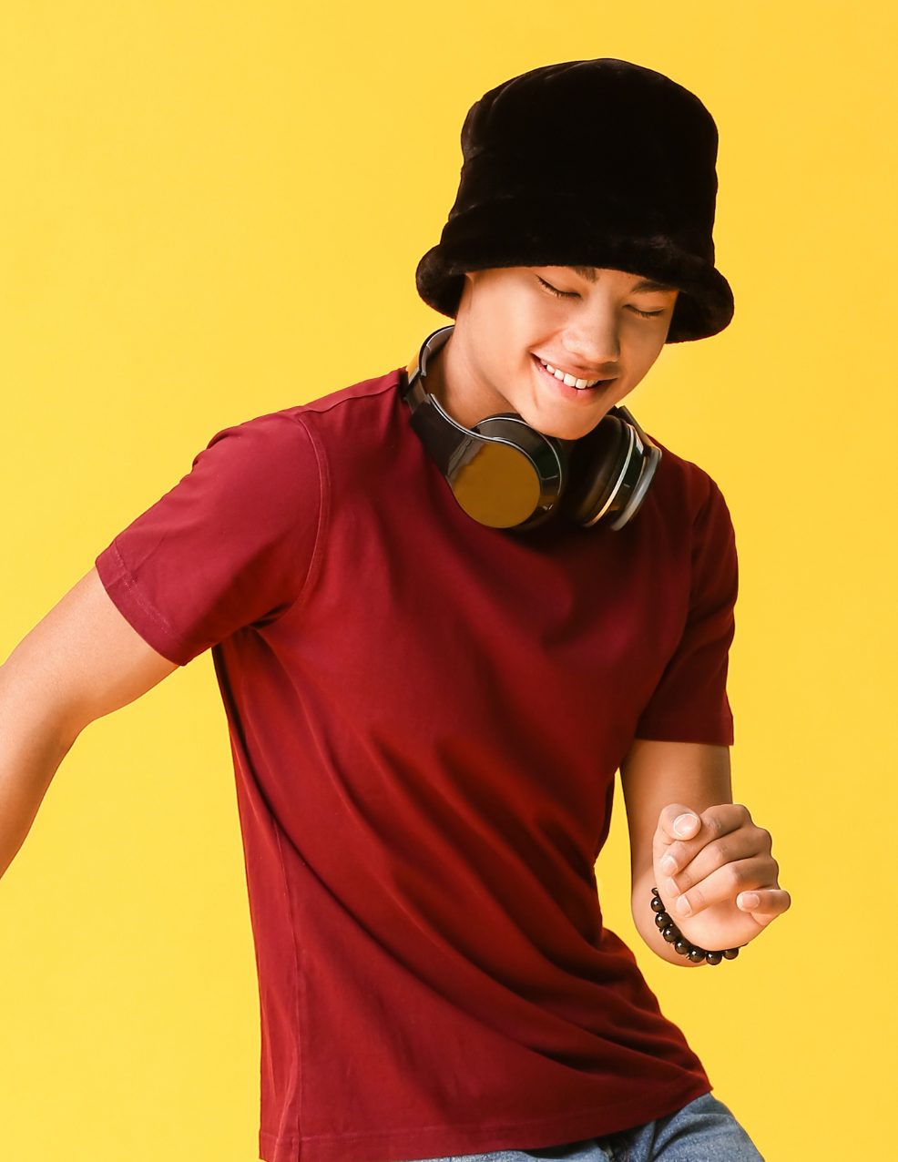 dancing boy with headphones and bucket hat