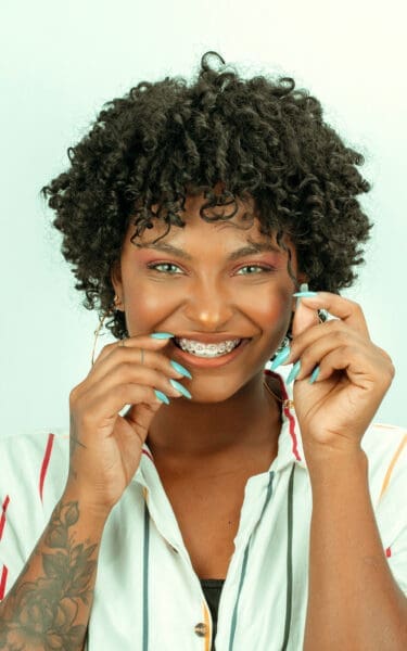 Woman with braces and blue nails