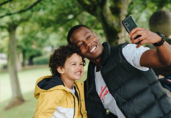 Dad and son taking a picture in the park
