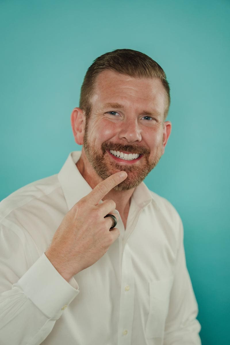 tooth-by-tooth-orthodontics-dr-nishant-patel-clear-aligners-main-pointing-to-smile-teeth