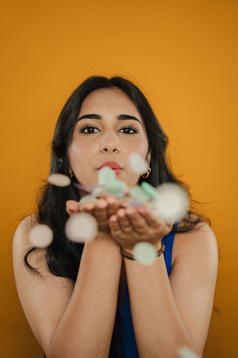 tooth-by-tooth-orthodontics-tooth-by-tooth-dr-patel-home-slider-girl-patient-blowing-confetti