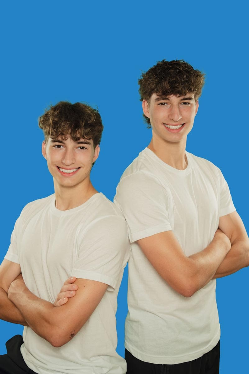 tooth-by-tooth-orthodontics-tooth-by-tooth-dr-patel-retainers-twin-boys-patient-smiling-posing-arms-folded