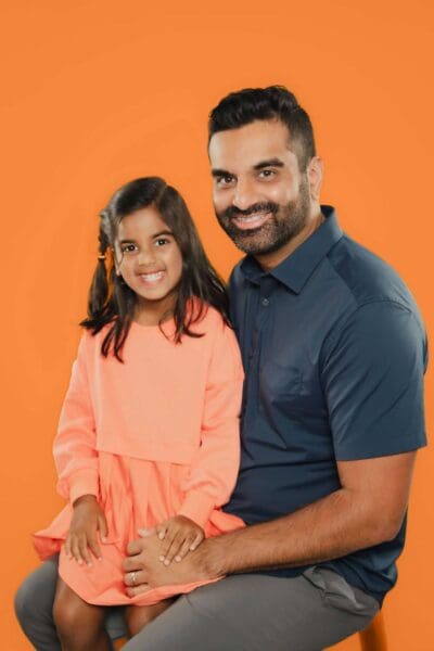 Dr. Nishant Patel with a teen patient and her parent at Tooth by Tooth Orthodontics in Cary, NC